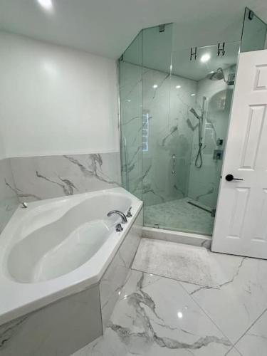a bathroom with a tub and a glass shower at Private Luxury Full Home in Markham in Markham