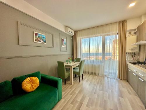 a living room with a green couch and a table at Blue Summerland Apartments in Mamaia