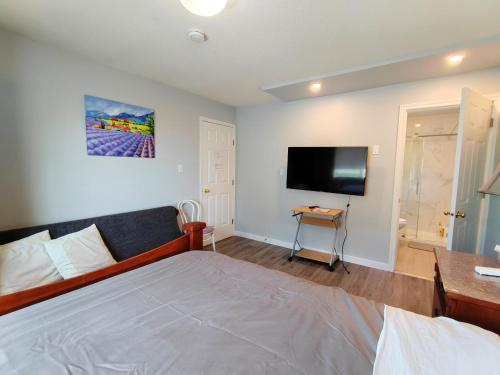 a bedroom with a bed and a flat screen tv at Better Bed in Richmond