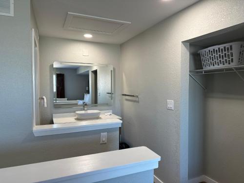a bathroom with a sink and a mirror at Arbor Suites at the Mall in Springfield