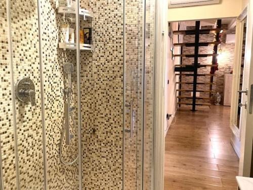 a bathroom with a shower with a glass door at Residence il Cascinale in Peschiera del Garda