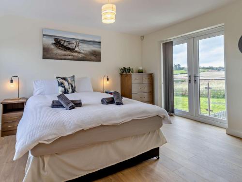 a bedroom with a large bed and a large window at 4 Bed in Bishops Castle 94072 in Bishops Castle