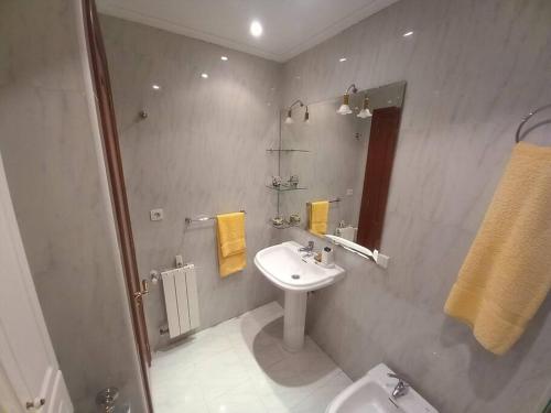 a bathroom with a sink and a toilet at Chalet adosado a 100 mts playa in Laredo