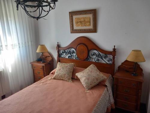 a bedroom with a bed with two pillows on it at Chalet adosado a 100 mts playa in Laredo