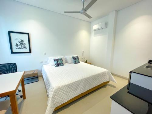 1 dormitorio con 1 cama, escritorio y TV en Apartaestudio Brumilo 2, en Montería