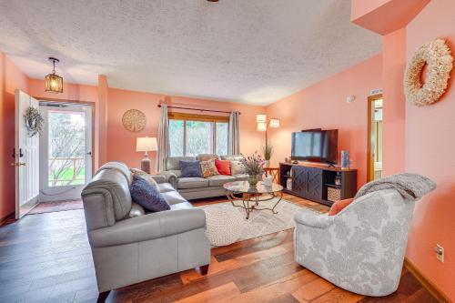 a living room with two couches and a tv at Dog-Friendly Michigan Home with Deck and Fire Pit! in Central Lake