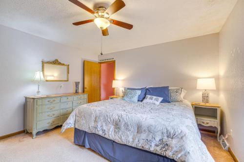 a bedroom with a bed and a ceiling fan at Dog-Friendly Michigan Home with Deck and Fire Pit! in Central Lake