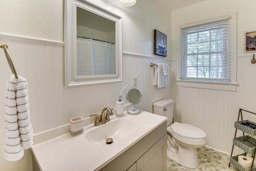 a white bathroom with a sink and a toilet at Elizabeth City Abode with Fenced Yard, Near Downtown in Elizabeth City