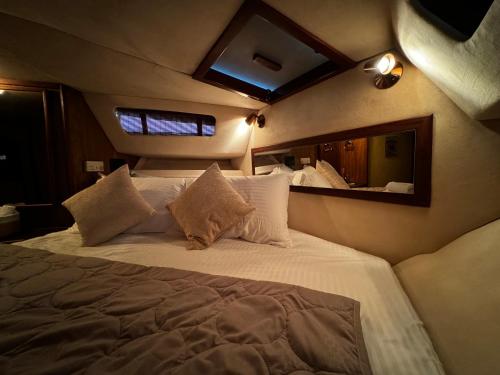 ein großes Bett in einem Zimmer mit Spiegel in der Unterkunft Eva’s Yatch Stay in Athen