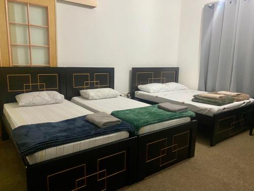 two twin beds in a room with at A Home Away From Home in Abu Dhabi