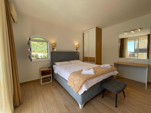 a bedroom with a large bed and a mirror at Guest house Villa Slavica in Sveti Stefan