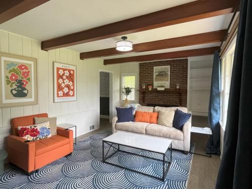 a living room with a couch and a table at Sapphire Shire in Winston-Salem