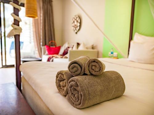 a hotel room with two towels on a bed at Tamala Beach Resort in Kotu
