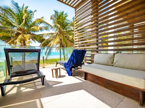 a living room with a couch and a chair at Tamala Beach Resort in Kotu