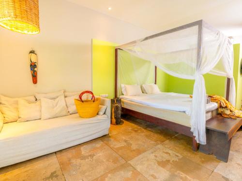 a living room with two beds and a couch at Tamala Beach Resort in Kotu