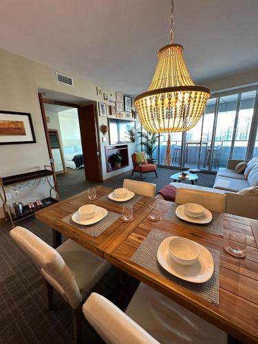a living room with a wooden table and a chandelier at Brickell Floor 31 Sea View-Free Parking by Palermo Home Miami in Miami