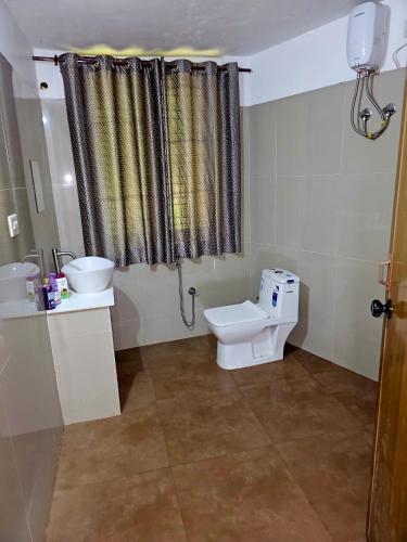 a bathroom with a toilet and a sink at GB25 inn in Trivandrum