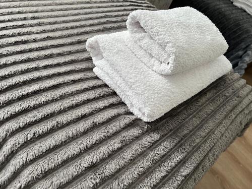 a pile of towels sitting on top of a bed at Готель «У Батька» in Truskavets