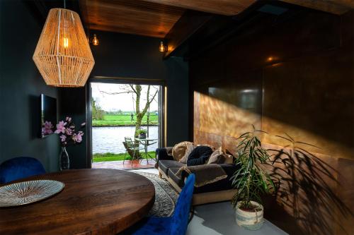a living room with a couch and a table at De koperslager in Watergang