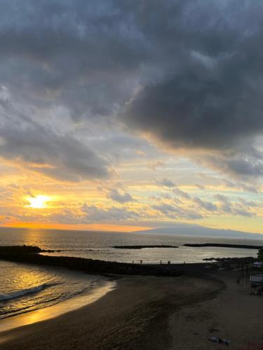 a sunset on a beach with the ocean and the sky at Tenerife Paradise Anna Studio in Adeje