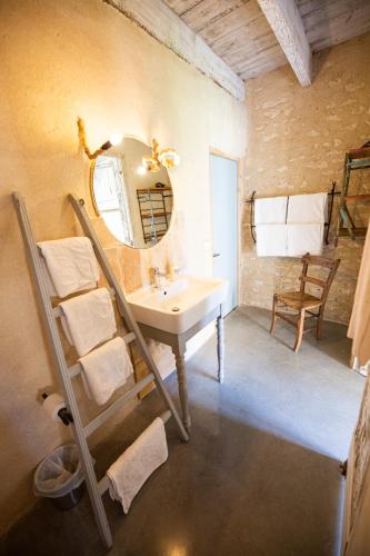 a bathroom with a sink and a mirror at Domaine De Chantemerle B'nB in Marsac