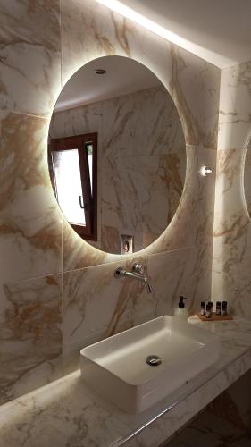 a bathroom with a sink and a mirror at Poseidon villa m ammos in Skiathos