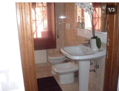 bagno con lavandino e servizi igienici di La Maison Blanche a Borghesiana