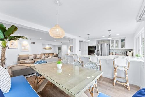a living room and kitchen with a table and chairs at Stunning Bayfront Home w Epic Dock on Peninsula in Newport Beach