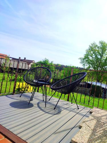two black chairs sitting on top of a deck at APARTMA KAPELSKI FANT in Sveti Jurij ob Ščavnici