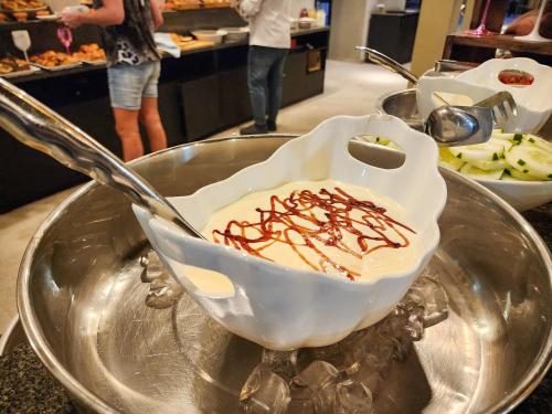 a dessert in a bowl with a spoon on a table at Tamala Beach Resort in Kotu