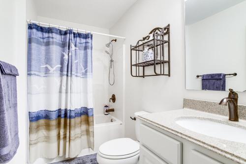 a bathroom with a toilet and a sink at Near Beaches and Shops Canal-Front Selbyville Home in Selbyville