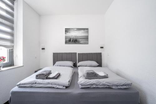 a bed with two pillows on it in a room at Duisburger Hostel in Duisburg