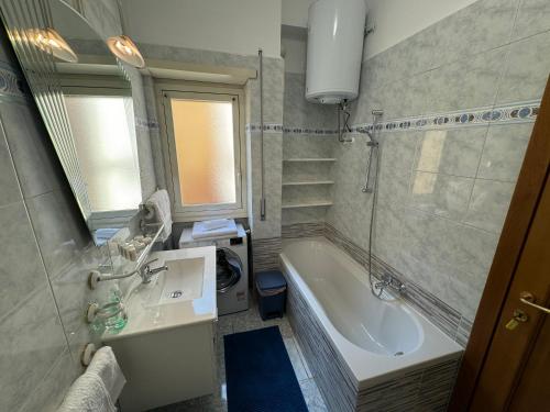 a bathroom with a tub and a sink and a bath tub at Rome elegant apartment in Rome
