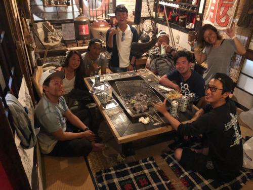 grupa ludzi siedzących przy stole w pokoju w obiekcie OKESYOU - Vacation STAY 55986v w mieście Niijimamura