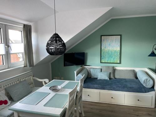 a living room with a bed and a table at Aparthotel Domizil in Borkum