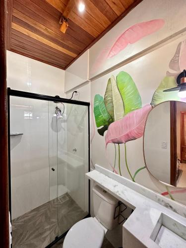 a bathroom with a shower and a toilet and a mirror at Apartamento coração de Santarém in Santarém