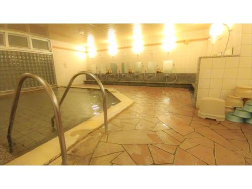 a bathroom with a swimming pool and a toilet at Rishiri Fuji Kanko Hotel - Vacation STAY 63414v in Oshidomari