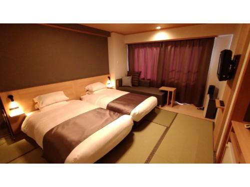En eller flere senge i et værelse på Rishiri Fuji Kanko Hotel - Vacation STAY 63414v