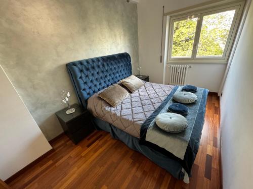 a bedroom with a blue bed with pillows on it at Rome elegant apartment in Rome