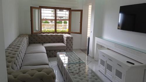 a living room with a couch and a television at Fantástic apartment the beach marina 2 in Tetouan