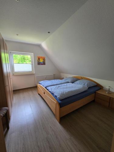 a bedroom with a bed and a window at Warendorf 12 in Warendorf