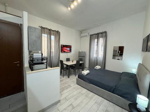 a bedroom with a bed and a table in it at Civico 10 II in Sassari