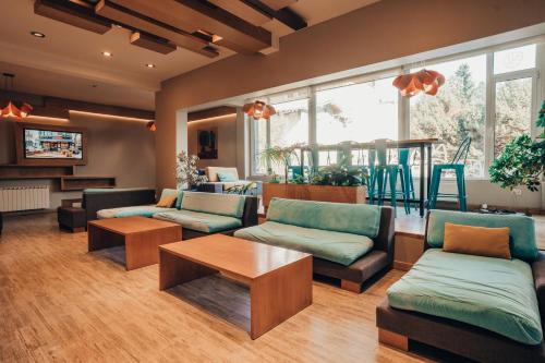 a living room with couches and a table at Hotel EcoSki by bund in San Carlos de Bariloche