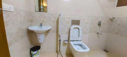 a bathroom with a toilet and a sink at Captains Cabin backwater resort in Alleppey