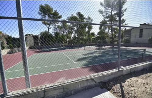 a tennis court with two tennis courts at Strip in Las Vegas
