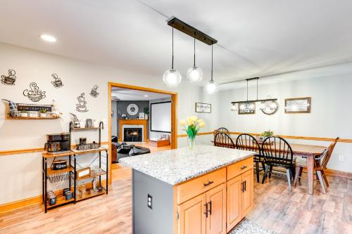 a kitchen and dining room with a table and a counter at Pet-Friendly Pocono Lake Home with Private Hot Tub! in Pocono Lake