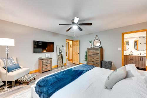 a bedroom with a large bed and a ceiling fan at Pet-Friendly Pocono Lake Home with Private Hot Tub! in Pocono Lake