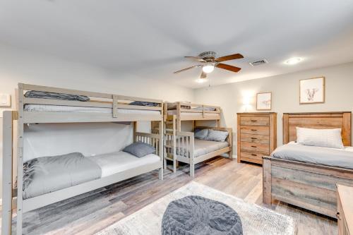 a room with two bunk beds and a ceiling fan at Pet-Friendly Pocono Lake Home with Private Hot Tub! in Pocono Lake