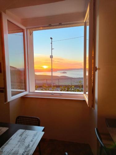 a window with a view of a lighthouse at Locanda Maddalena - Accoglienza Pellegrini in Montefiascone