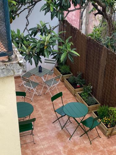 a patio with a table and chairs and a fence at Terrace House in Lisbon